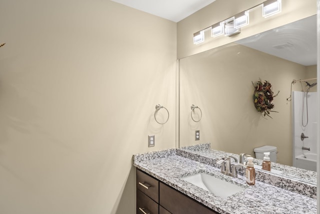 bathroom with vanity, bathtub / shower combination, and toilet