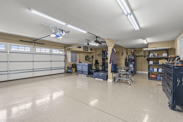 garage with a garage door opener, water heater, and baseboards