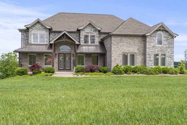 craftsman-style home with french doors, a front yard, a standing seam roof, and roof with shingles