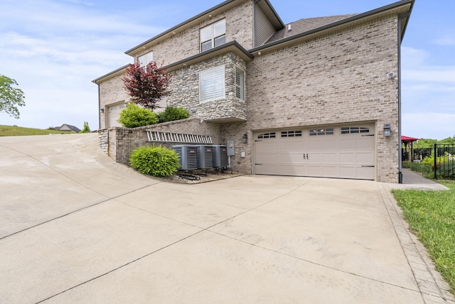 view of front facade with concrete driveway, brick siding, and an attached garage