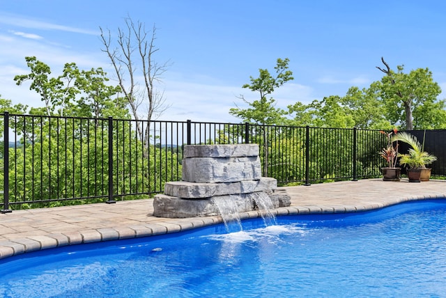 view of pool featuring fence