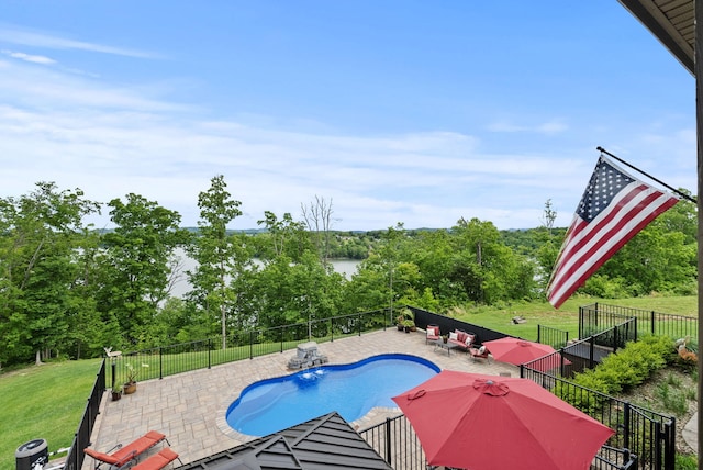 view of pool with a patio area, central AC unit, and view of scattered trees