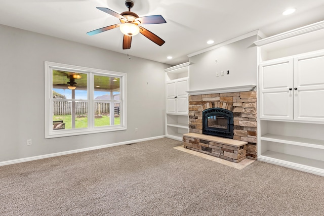 unfurnished living room with baseboards, recessed lighting, a ceiling fan, a stone fireplace, and carpet floors