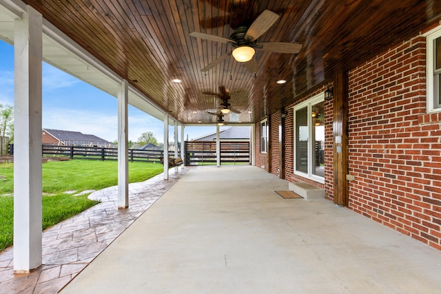 view of patio featuring fence and a ceiling fan