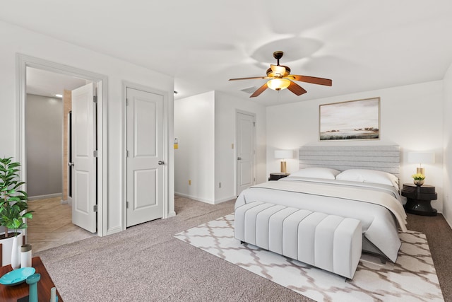 bedroom featuring baseboards, a ceiling fan, and light carpet