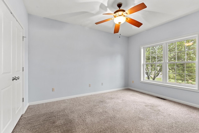 unfurnished room featuring ceiling fan, baseboards, and carpet flooring