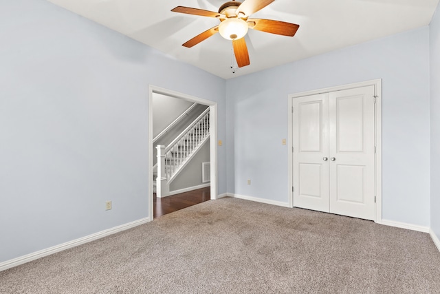 unfurnished bedroom featuring carpet, a closet, baseboards, and visible vents