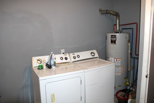 laundry room with washer and clothes dryer and gas water heater