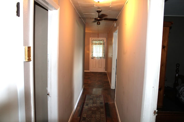 hall with baseboards and dark wood finished floors