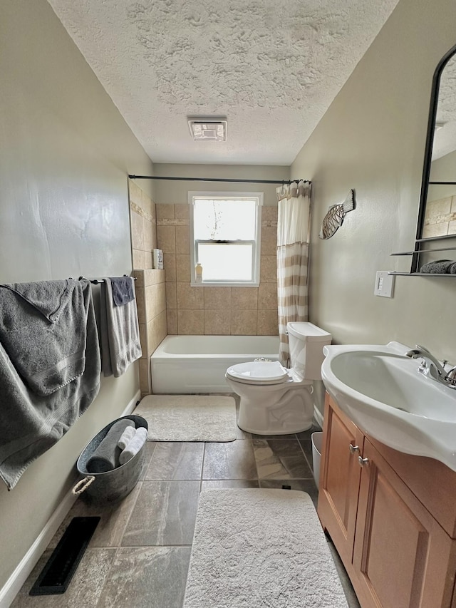 bathroom featuring vanity, shower / bath combination with curtain, toilet, visible vents, and a textured ceiling