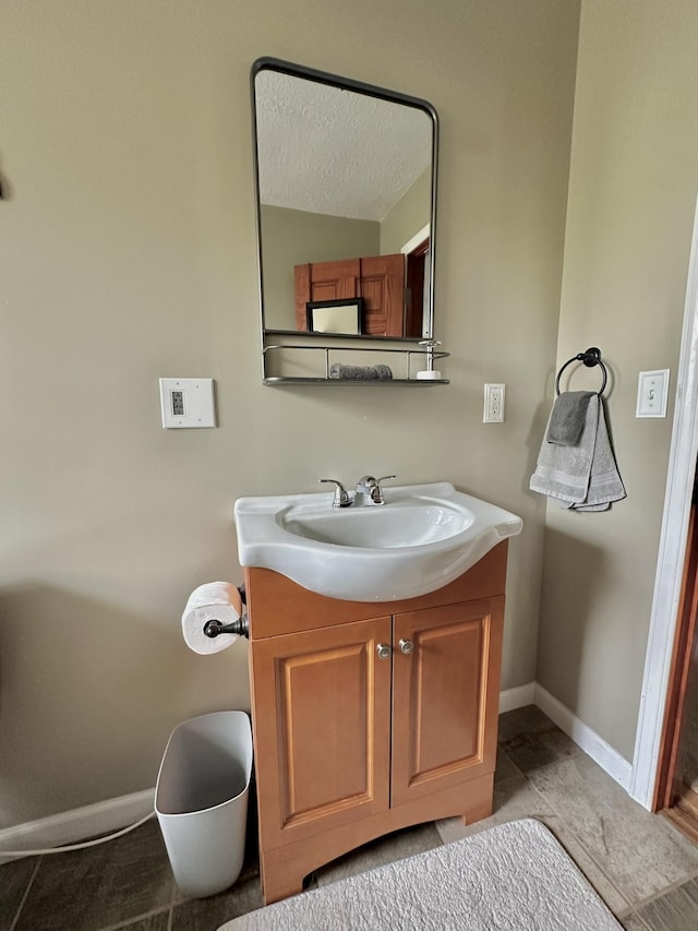 bathroom with vanity and baseboards