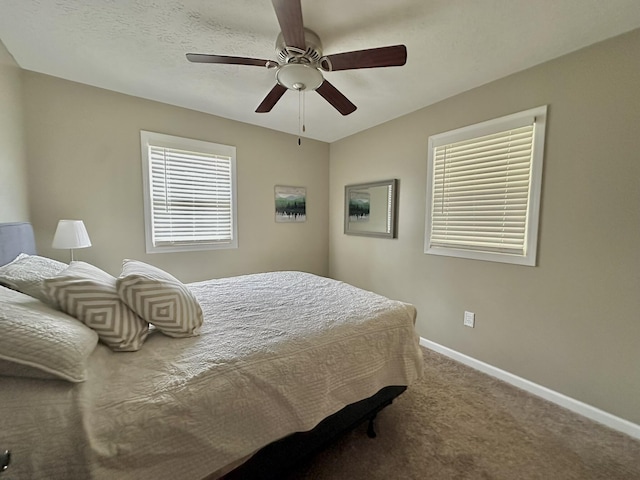 carpeted bedroom featuring a ceiling fan and baseboards