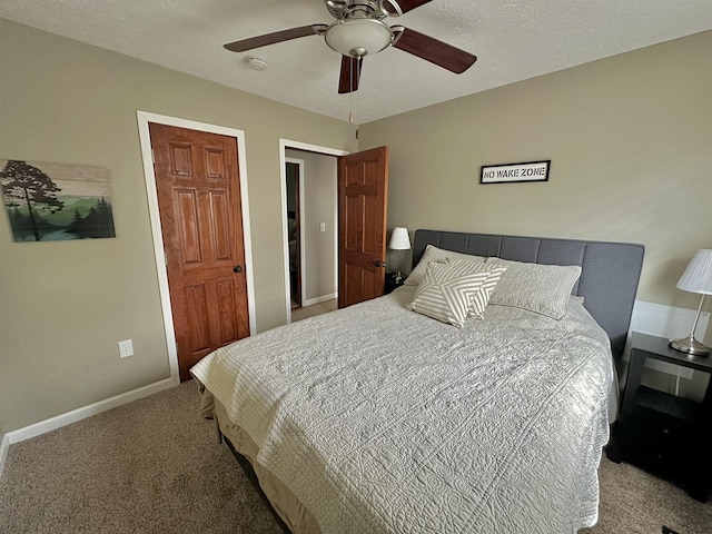 carpeted bedroom with ceiling fan and baseboards