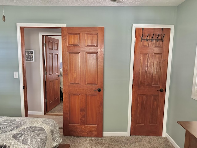 carpeted bedroom featuring baseboards