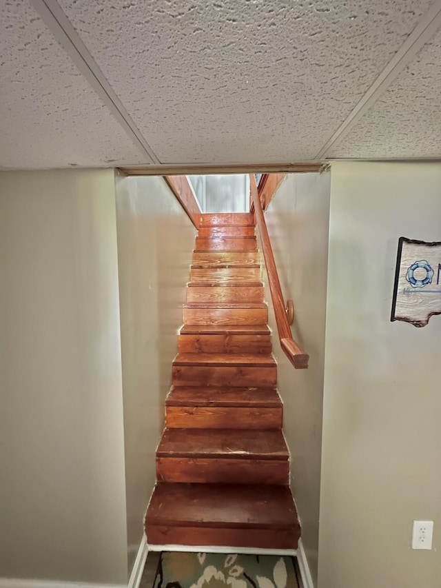 stairway featuring baseboards