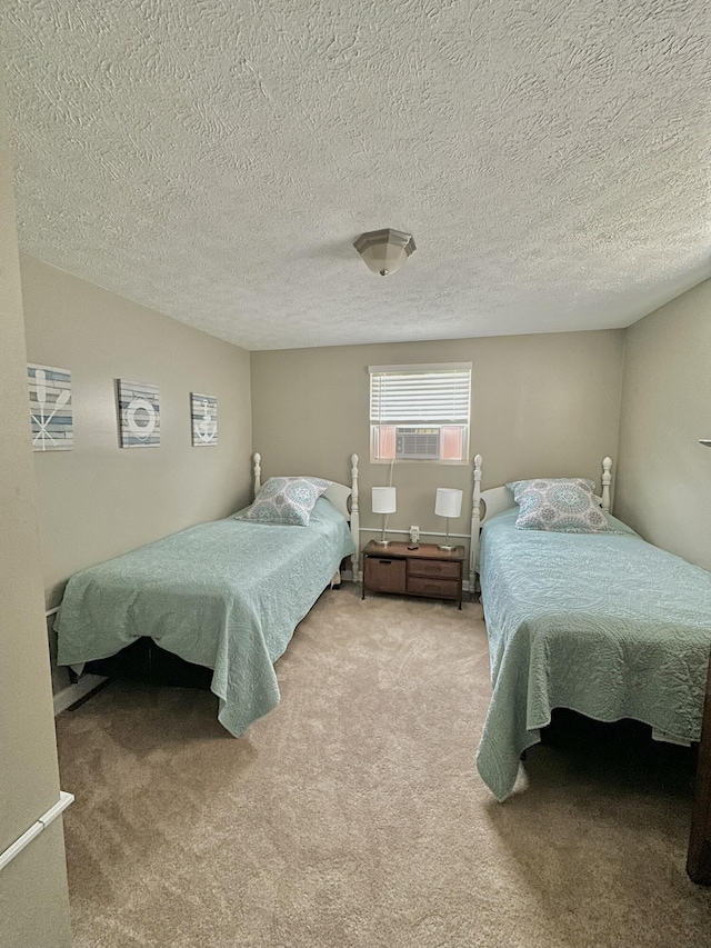 bedroom featuring cooling unit, a textured ceiling, and carpet