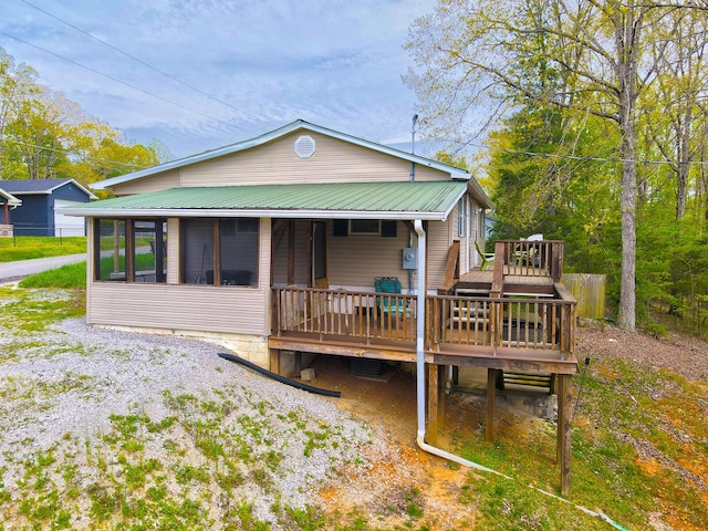 rear view of property with a wooden deck