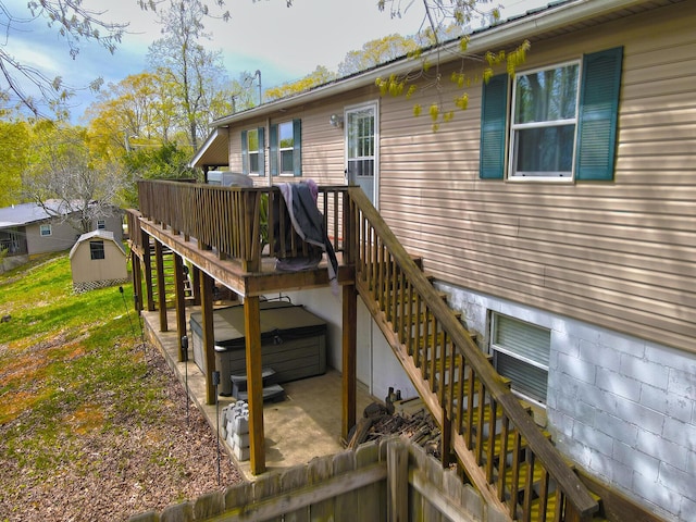 wooden deck featuring a patio, stairway, and a hot tub