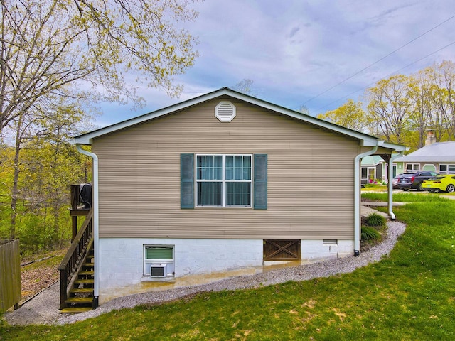 view of home's exterior featuring stairway and a yard