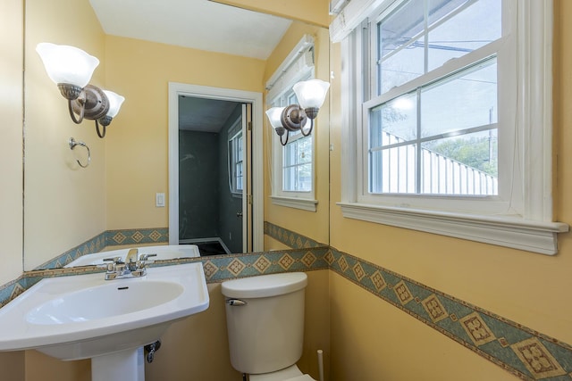 half bathroom featuring toilet and a sink