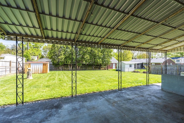 view of patio / terrace featuring a storage shed, an outbuilding, a residential view, and a fenced backyard