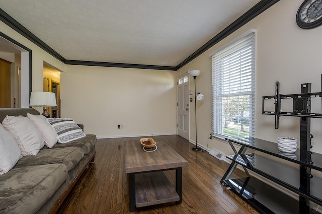 living room with baseboards, visible vents, wood finished floors, and crown molding