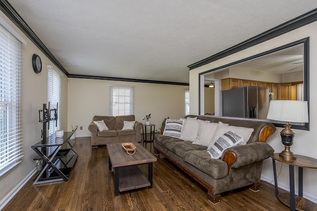 living area with crown molding, a textured ceiling, wood finished floors, and baseboards