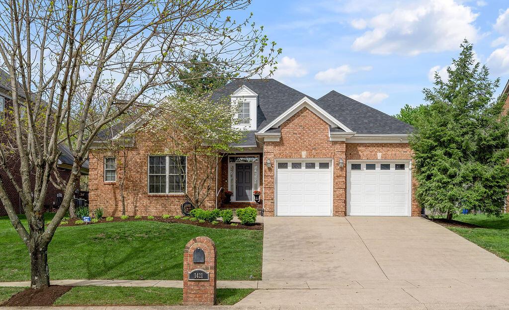 1421 Saddle Club Way, Lexington, KY 40504 - traditional-style home with driveway, an attached garage, a front yard, brick siding, and roof with shingles