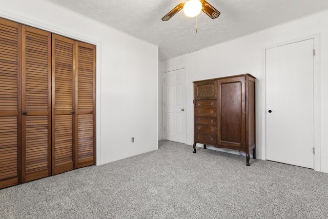370 Poplar Ln, Morehead, KY 40351 - unfurnished bedroom featuring a ceiling fan, a textured ceiling, a closet, and light colored carpet