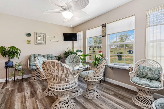 dining room featuring baseboards, a ceiling fan, and wood finished floors