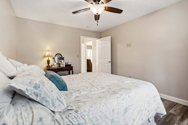 bedroom with baseboards, ceiling fan, and wood finished floors