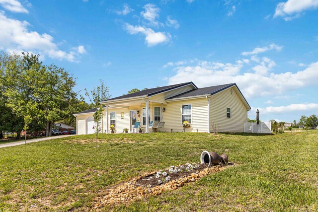 ranch-style home with an attached garage and a front yard