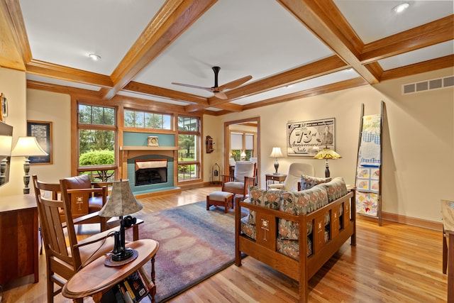 living area with beam ceiling, visible vents, and coffered ceiling
