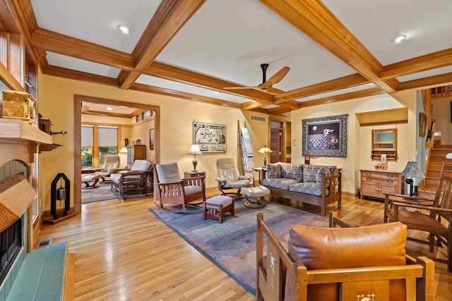 living room featuring coffered ceiling, a fireplace, baseboards, and ceiling fan