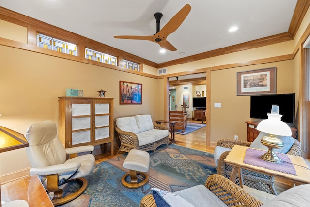 living room featuring crown molding, baseboards, a ceiling fan, and recessed lighting