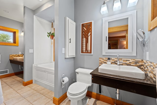 bathroom featuring a sink, toilet, a bathtub, visible vents, and tile patterned flooring
