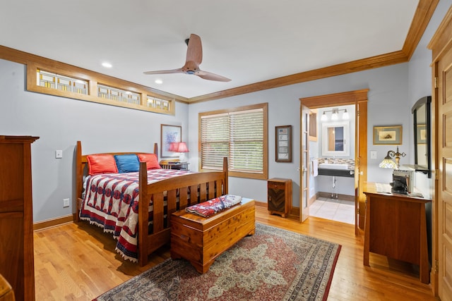 bedroom with ensuite bath, light wood-type flooring, crown molding, ceiling fan, and baseboards
