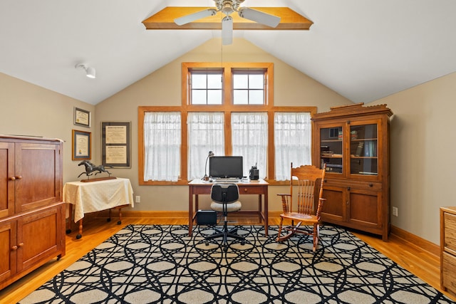 office featuring high vaulted ceiling, light wood-style flooring, baseboards, and a ceiling fan