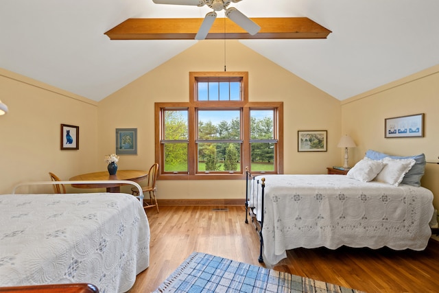 bedroom with baseboards, ceiling fan, high vaulted ceiling, wood finished floors, and beamed ceiling