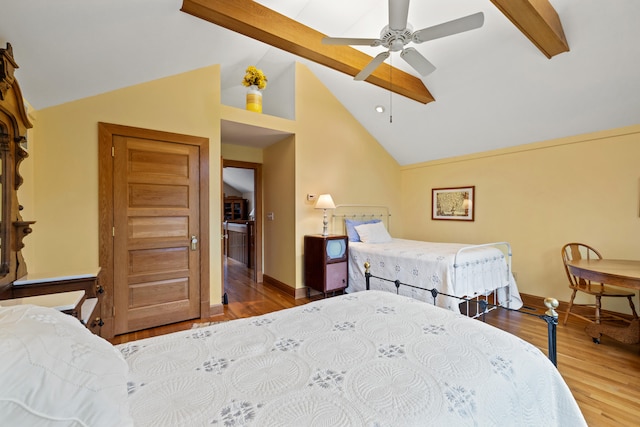 bedroom featuring baseboards, ceiling fan, vaulted ceiling with beams, and wood finished floors