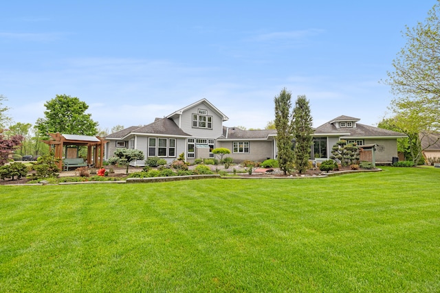 rear view of property featuring a lawn