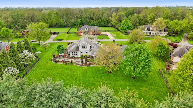 bird's eye view with a wooded view