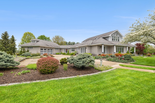 view of front of home with a front yard and brick siding