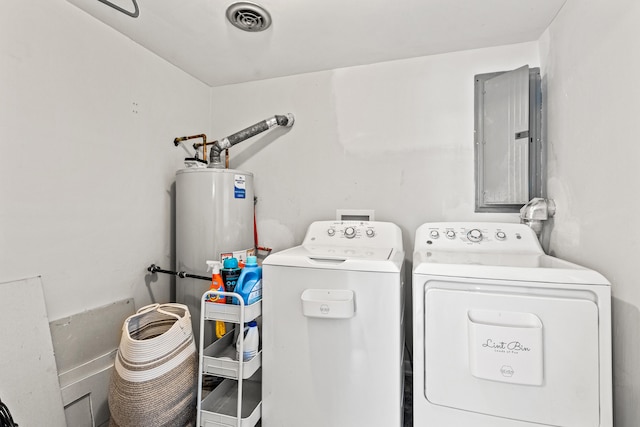 washroom featuring gas water heater, washer and dryer, electric panel, and laundry area