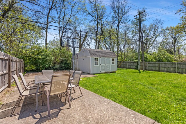 view of yard with a fenced backyard, an outbuilding, a patio, outdoor dining area, and a shed