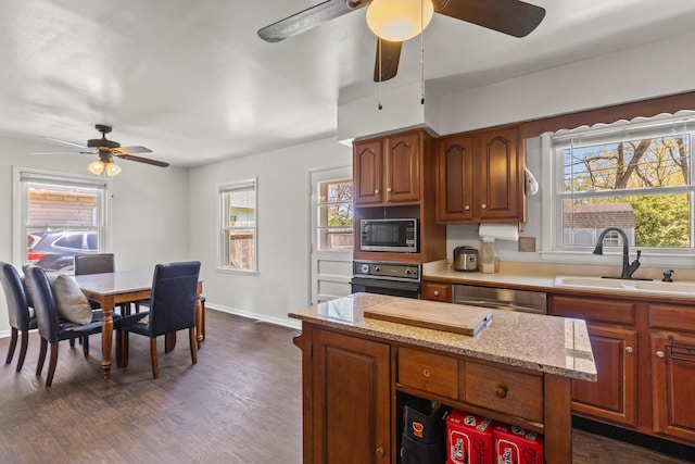kitchen with oven, dishwasher, a sink, built in microwave, and a ceiling fan