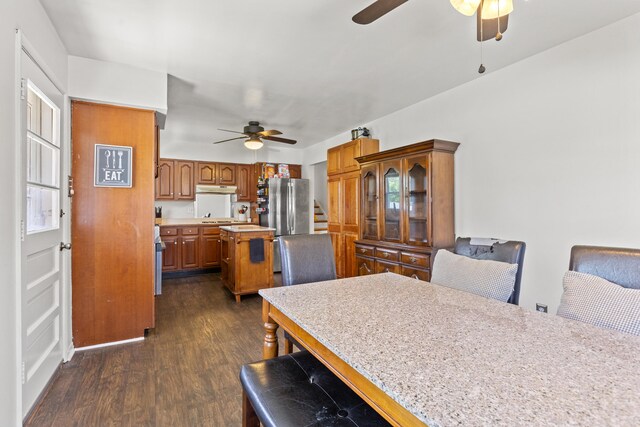 dining space featuring stairway, a ceiling fan, and dark wood-style floors
