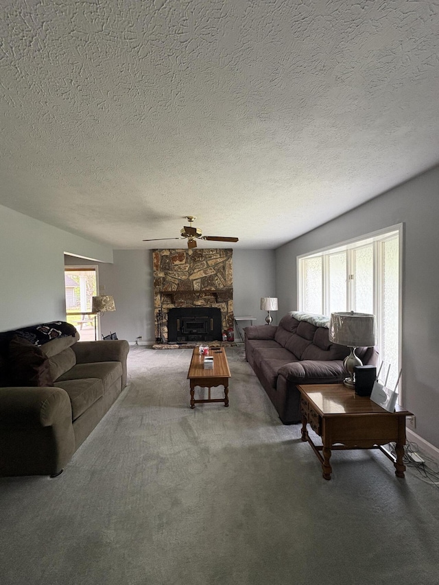 102 Locust St, Manchester, KY 40962 - carpeted living room featuring a textured ceiling, a stone fireplace, a healthy amount of sunlight, and ceiling fan