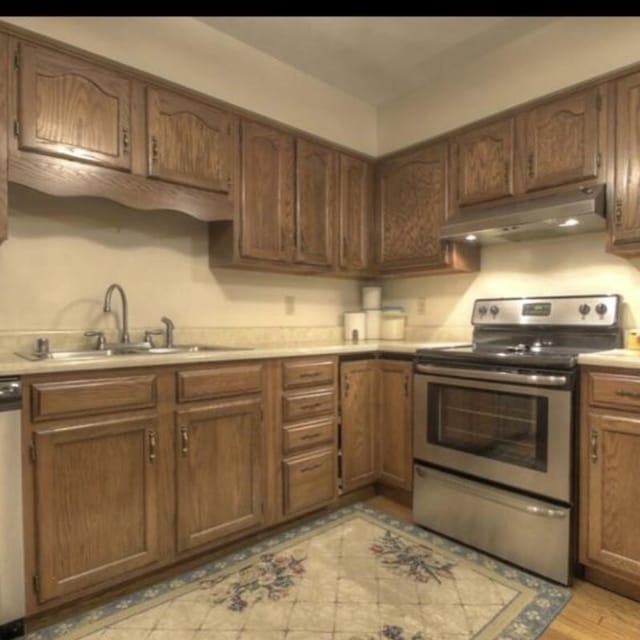 102 Locust St, Manchester, KY 40962 - kitchen featuring light countertops, appliances with stainless steel finishes, under cabinet range hood, and a sink