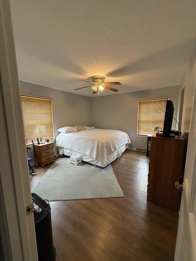102 Locust St, Manchester, KY 40962 - bedroom with a textured ceiling, a ceiling fan, and dark wood-style flooring